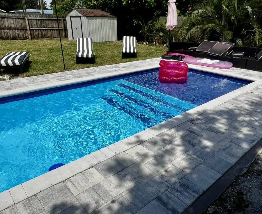 California pool with tanning ledge and loungers