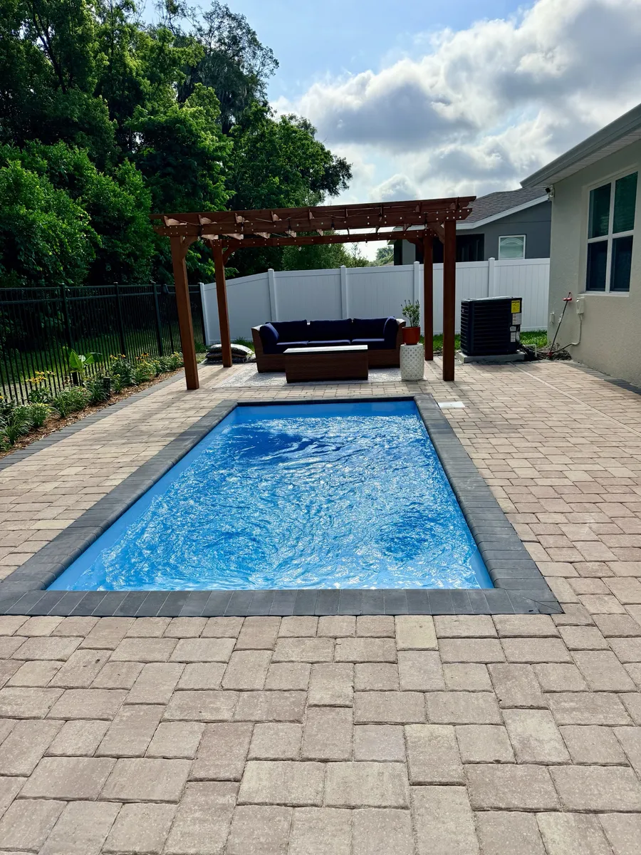 Wood pergola next to a pool we built